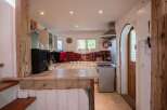 Discover the charm of this property, featuring a rustic kitchen with wooden accents and a cozy atmosphere.