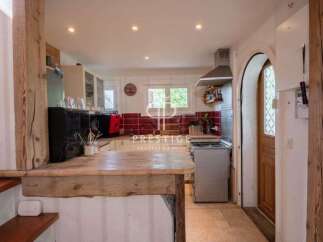 Discover the charm of this property, featuring a rustic kitchen with wooden accents and a cozy atmosphere.