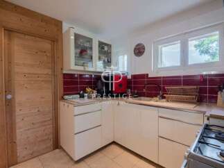 Discover a charming kitchen with a rustic wooden door and cabinetry.