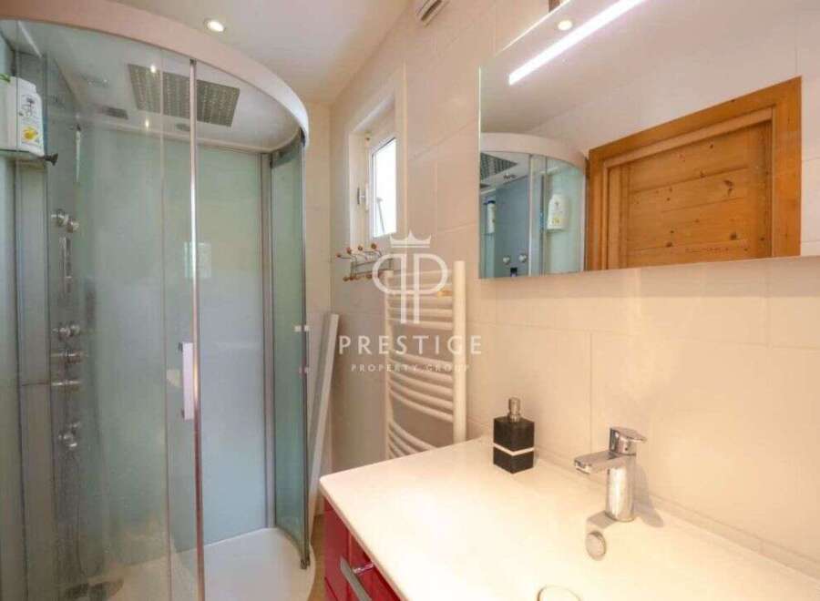 Discover a luxurious bathroom with a modern shower and elegant design.