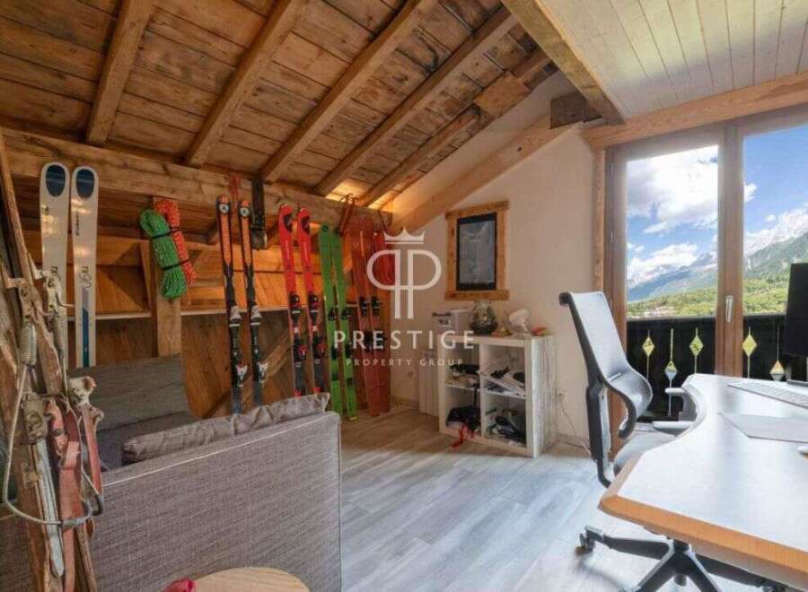 Discover the charm of this stunning property, featuring a cozy interior with wooden accents and a breathtaking mountain view.