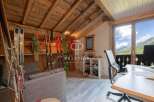 Discover the charm of this stunning property, featuring a cozy interior with wooden accents and a breathtaking mountain view.