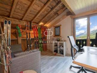 Discover the charm of this stunning property, featuring a cozy interior with wooden accents and a breathtaking mountain view.