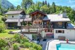 Discover a stunning chalet nestled in a picturesque mountain setting.