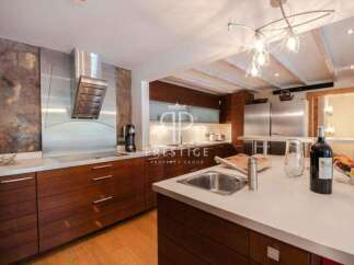 Discover luxury living in this stunning kitchen! Featuring sleek stainless steel appliances, rich wooden cabinetry, and a modern design, this space is perfect for both cooking and entertaining.
