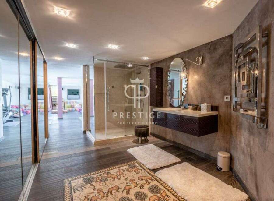 Discover luxury living at its finest! This stunning property boasts a modern bathroom with a sleek glass shower and elegant floating vanity.