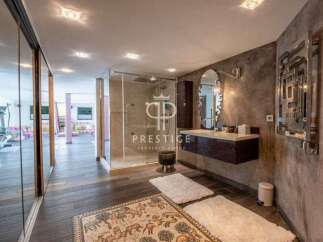 Discover luxury living at its finest! This stunning property boasts a modern bathroom with a sleek glass shower and elegant floating vanity.
