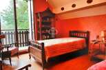 Discover the charm of this cozy bedroom, featuring a warm and inviting ambiance.