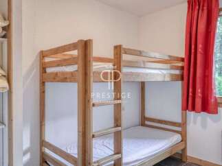 Discover a cozy bedroom featuring a charming wooden bunk bed, perfect for accommodating guests or family.