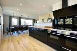 Discover modern living in this stunning property, featuring a sleek, contemporary kitchen with state-of-the-art appliances.