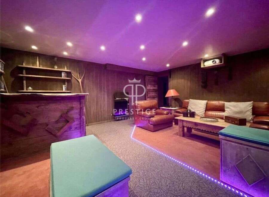 Step into luxury with this stunning property! Featuring a cozy living area with a projector, perfect for movie nights.