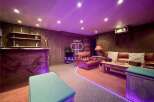 Step into luxury with this stunning property! Featuring a cozy living area with a projector, perfect for movie nights.