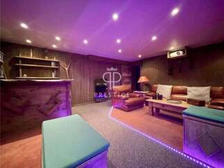 Step into luxury with this stunning property! Featuring a cozy living area with a projector, perfect for movie nights.
