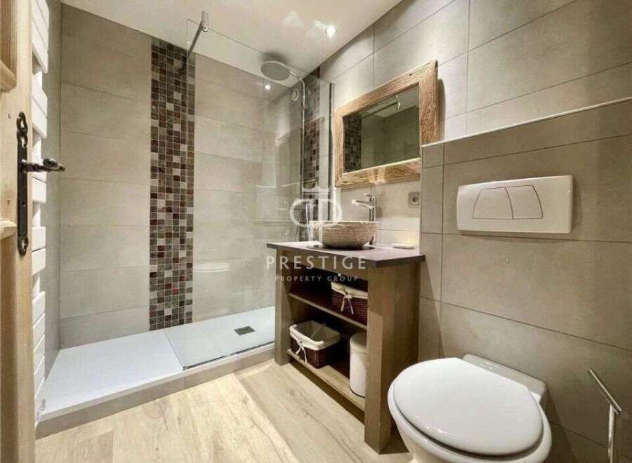 Discover a modern bathroom design featuring a sleek walk-in shower and stylish tile accents.