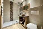 Discover a modern bathroom design featuring a sleek walk-in shower and stylish tile accents.