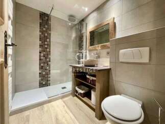 Discover a modern bathroom design featuring a sleek walk-in shower and stylish tile accents.
