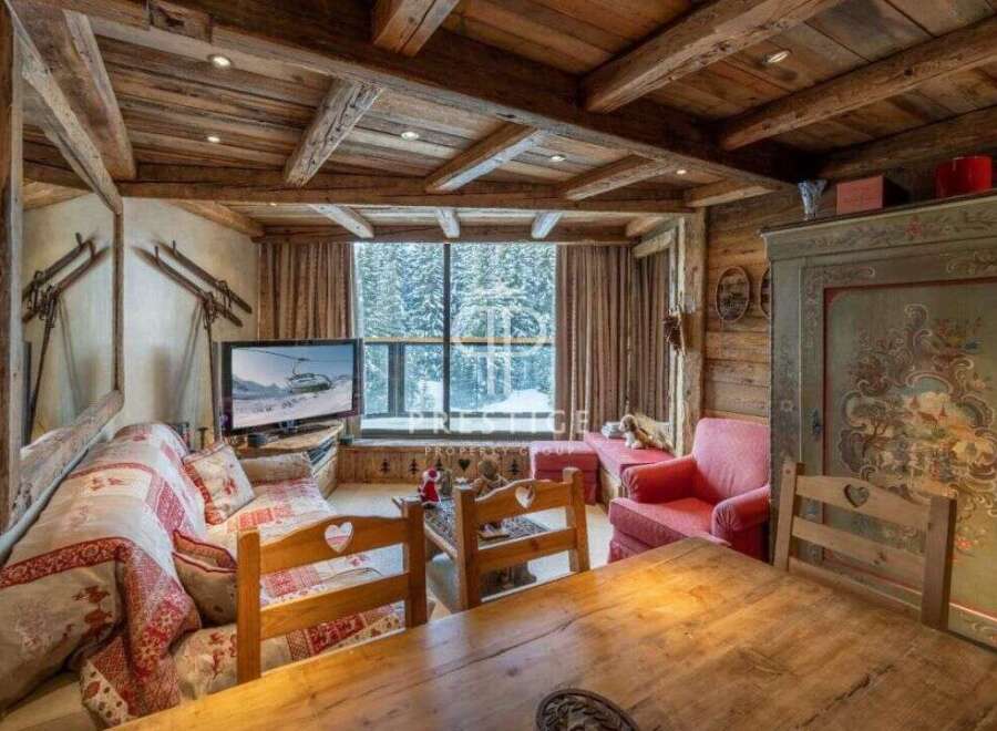 Experience the charm of this cozy chalet, featuring a rustic wooden interior and a stunning view of the snowy landscape.