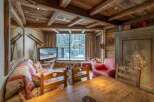 Experience the charm of this cozy chalet, featuring a rustic wooden interior and a stunning view of the snowy landscape.