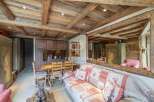 Discover rustic charm in this cozy living space, featuring exposed wooden beams and a warm, inviting atmosphere.
