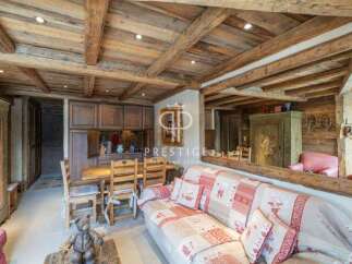 Discover rustic charm in this cozy living space, featuring exposed wooden beams and a warm, inviting atmosphere.