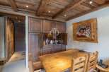 Discover rustic charm in this stunning property, featuring a warm wooden dining area perfect for gatherings.