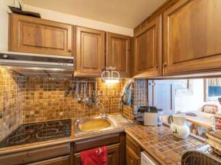 Discover the charm of this kitchen, featuring warm wooden cabinetry and a stylish tiled backsplash.
