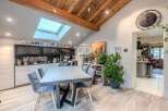 Discover the charm of this stunning property, featuring a modern dining area with a stylish table and chairs.