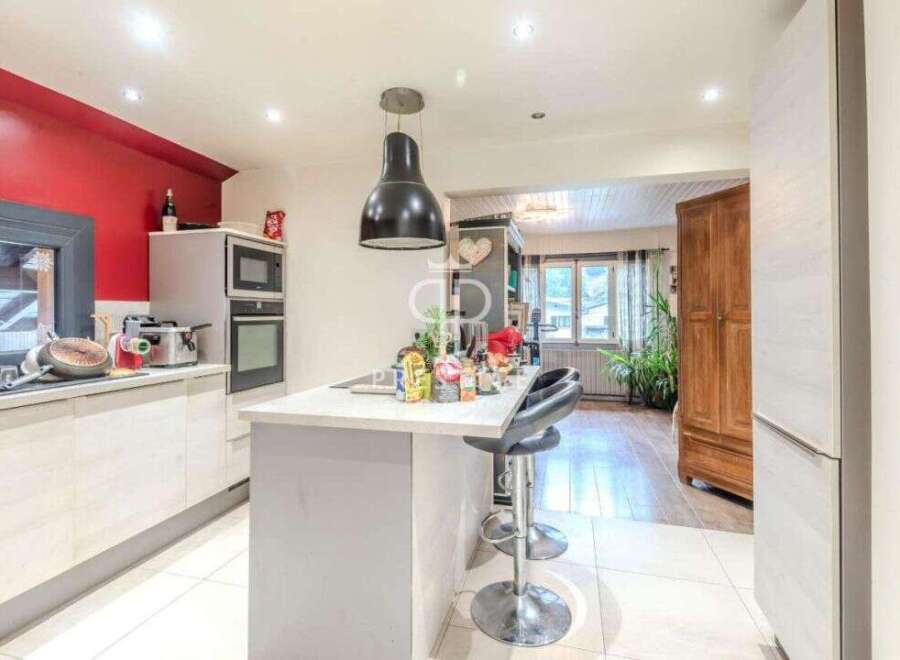 Discover this stunning kitchen with modern appliances and a stylish island, perfect for culinary enthusiasts.
