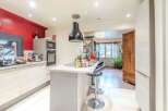 Discover this stunning kitchen with modern appliances and a stylish island, perfect for culinary enthusiasts.