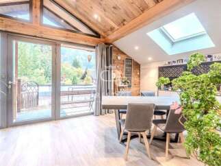 Experience the charm of this stunning property, featuring a bright and airy interior with a unique wooden ceiling.
