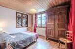 Charming bedroom with wooden accents and a cozy atmosphere.