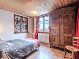 Charming bedroom with wooden accents and a cozy atmosphere.
