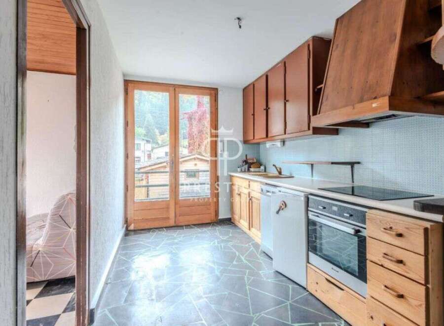 Discover a charming kitchen with wooden cabinets and a modern cooktop.