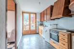 Discover a charming kitchen with wooden cabinets and a modern cooktop.