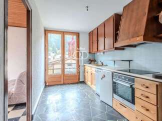 Discover a charming kitchen with wooden cabinets and a modern cooktop.