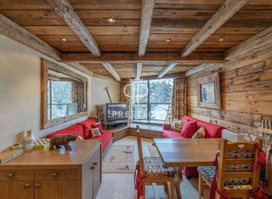 Experience rustic charm in this cozy living space, featuring a stunning wooden ceiling and walls.