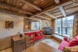 Experience the charm of this cozy chalet, featuring a rustic wooden ceiling and a warm, inviting atmosphere.