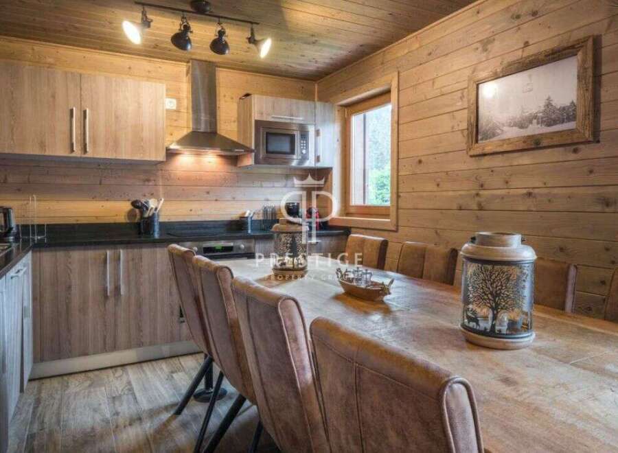 Experience rustic charm in this stunning property, featuring a beautifully designed kitchen with wooden cabinetry and modern appliances.