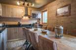 Experience rustic charm in this stunning property, featuring a beautifully designed kitchen with wooden cabinetry and modern appliances.