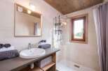 This charming bathroom features a modern design with a touch of rustic elegance.