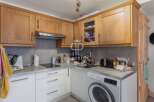 Discover this charming kitchen, featuring modern appliances and ample storage.