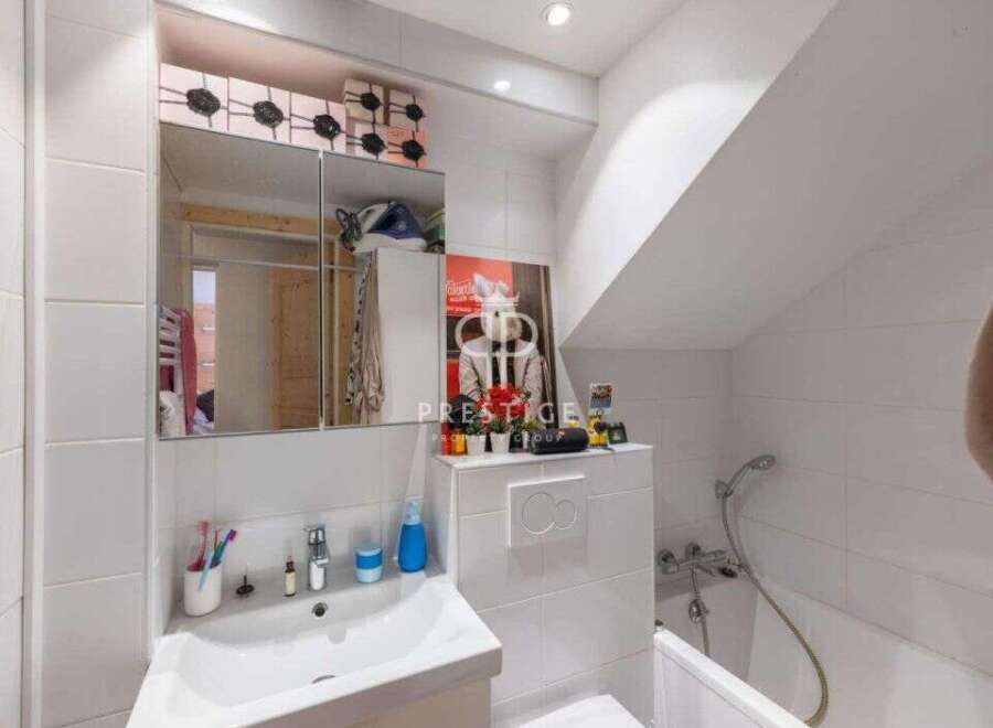 Discover this charming bathroom, featuring a modern sink and a convenient shower.