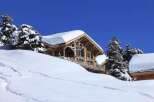 Discover a stunning chalet nestled in a winter wonderland.