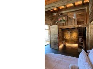 Discover rustic charm in this unique property, featuring stunning wooden architecture and a cozy loft space.
