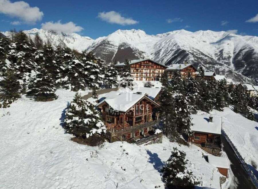 Discover a stunning mountain retreat nestled in a picturesque winter wonderland.