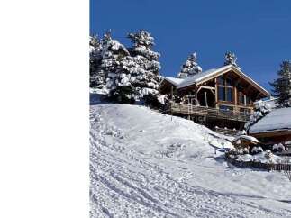 Experience the ultimate winter escape in this stunning chalet nestled in a snowy landscape.