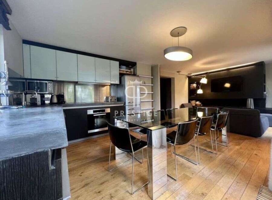 Modern and stylish interior design with a sleek kitchen and dining area.