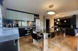 Modern and stylish interior design with a sleek kitchen and dining area.