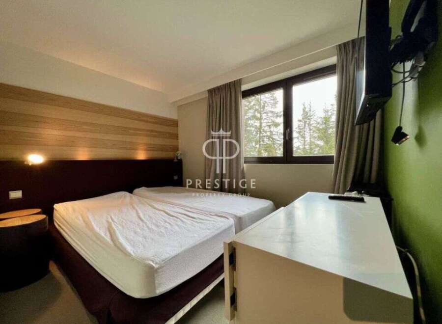 Discover a cozy bedroom with two comfortable beds, perfect for a relaxing stay.