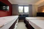 Discover a cozy bedroom featuring multiple beds, perfect for accommodating guests.